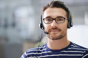 Portrait of a handsome young businessman wearing a headset in the office - Portrait of a handsome young businessman wearing a headset in the office